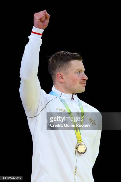 Gold medalist, Adam Peaty of Team England poses with their medal during the medal ceremony for the Men's 50m Breaststroke Final on day five of the...