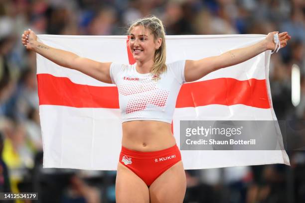 Molly Caudery of Team England celebrates with their countries flag after winning the Silver medal in the Women's Pole Vault Final on day five of the...