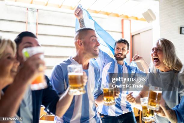 argentina team fans celebrating in a bar - argentinian culture stockfoto's en -beelden