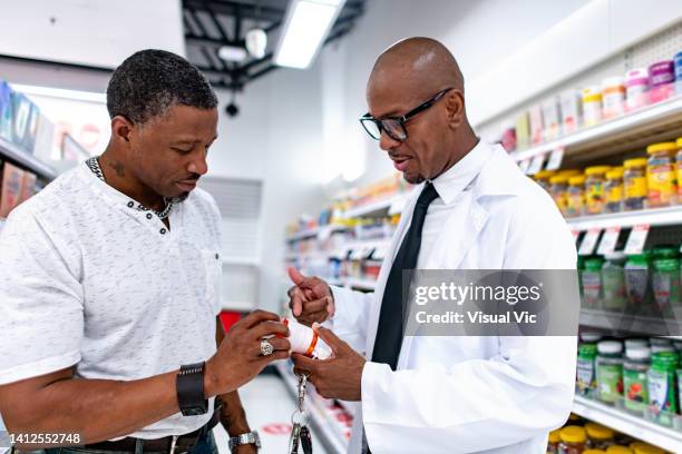 pharmacist on duty 2 - black pharmacist stock pictures, royalty-free photos & images