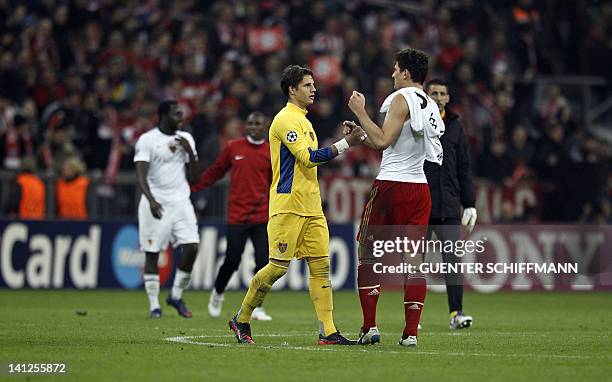 Basel's goalkeeper Yann Sommer shakes hands with Bayern Munich's striker Mario Gomez after the UEFA Champions League round of 16 second-leg match of...