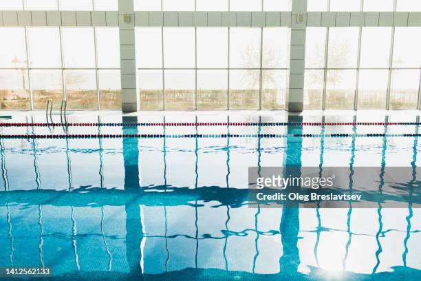 luxury indoor swimming pool interior. background with reflections in blue water - swimming pool texture stock pictures, royalty-free photos & images
