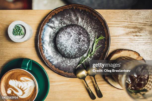 chocolate fondant cake on beautiful ceramic plate. top view - chocolate souffle stock-fotos und bilder