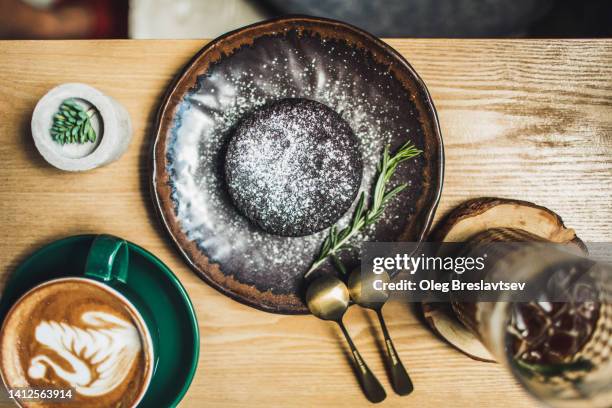 chocolate fondant cake on beautiful ceramic plate. top view - souffle stock pictures, royalty-free photos & images