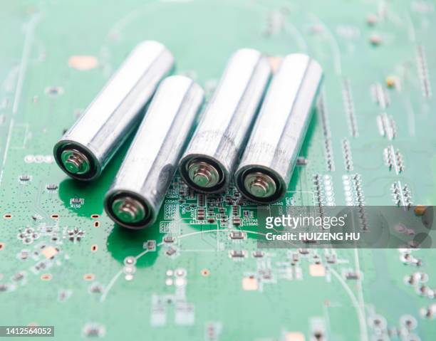 aa batteries on the blue circuit board - alkaline stock pictures, royalty-free photos & images