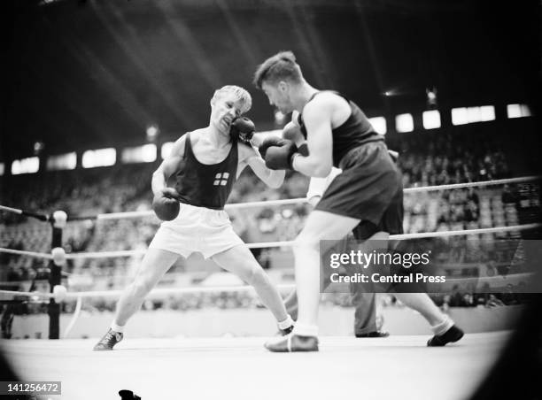 Harry Siljander of Finland in the ring with George Hunter of South Africa during match 3 of the quarter-finals of the men's light-heavyweight boxing...
