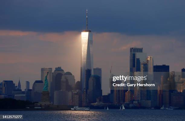 The sun sets on lower Manhattan, One World Trade Center and the Statue of Liberty in New York City on August 2 as seen from Jersey City, New Jersey.