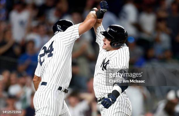 Josh Donaldson of the New York Yankees celebrates his sixth inning two run home run against the Seattle Mariners with teammate Matt Carpenter at...