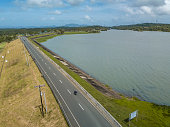 A highway traverses Lake Caliraya, a man-made lake at the border of Lumban and Cavinti in the province of Laguna, Philippines.