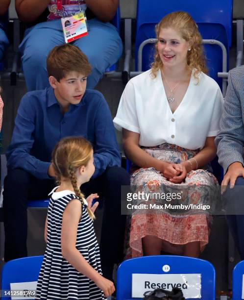 Princess Charlotte of Cambridge waves at James, Viscount Severn and Lady Louise Windsor as she arrives to watch the swimming during the 2022...