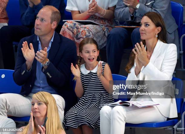 Prince William, Duke of Cambridge, Princess Charlotte of Cambridge and Catherine, Duchess of Cambridge watch the swimming competition at the Sandwell...