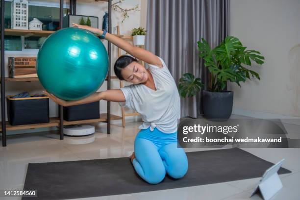 young woman working out with gym ball. - pilates ball man stock-fotos und bilder