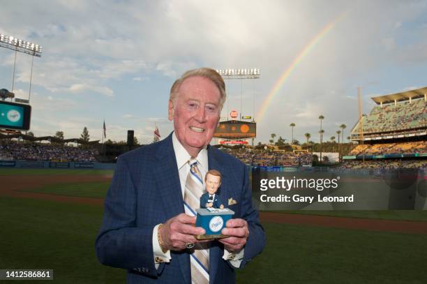 At Dodger Stadium with a rainbow over his shoulder Sportscaster Vin Scully poses for a portrait with a bobblehead of himself on August 30, 2012 in...