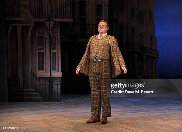 Cast member Owain Arthur bows at the curtain call during the press night performance of 'One Man, Two Guvnors' as it transfers to the Theatre Royal...