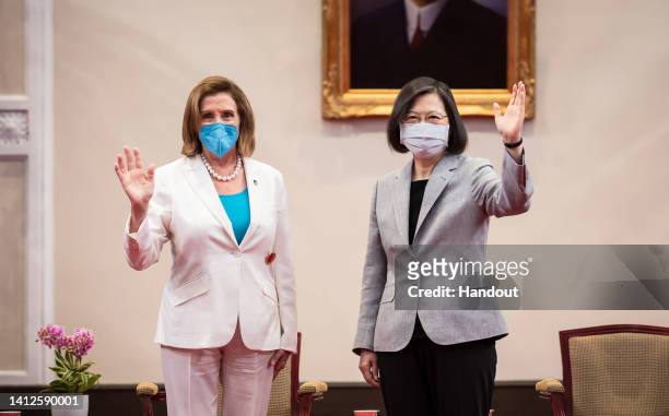 In this handout image provided by Office of The President, Speaker of the U.S. House Of Representatives Nancy Pelosi , left, poses for photographs...