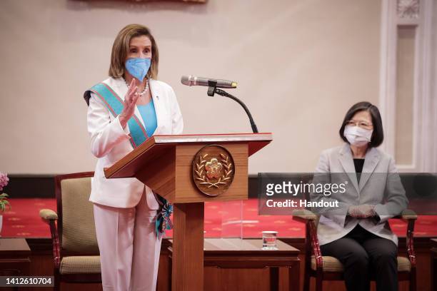 Speaker of the U.S. House Of Representatives Nancy Pelosi , left, speaks after receiving the Order of Propitious Clouds with Special Grand Cordon,...