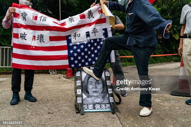 Pro-China supporter steps on a defaced photo of U.S. House of Representatives Speaker Nancy Pelosi during a protest against her visit to Taiwan...