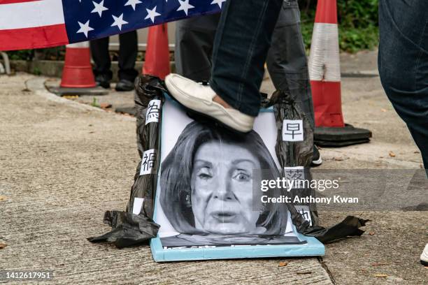 Pro-China supporter steps on a defaced photo of U.S. House of Representatives Speaker Nancy Pelosi during a protest against her visit to Taiwan...