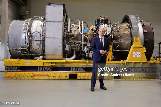 German Chancellor Olaf Scholz poses in front of the Siemens gas turbine intended for the Nord Stream 1 gas pipeline in Russia at a Siemens Energy...