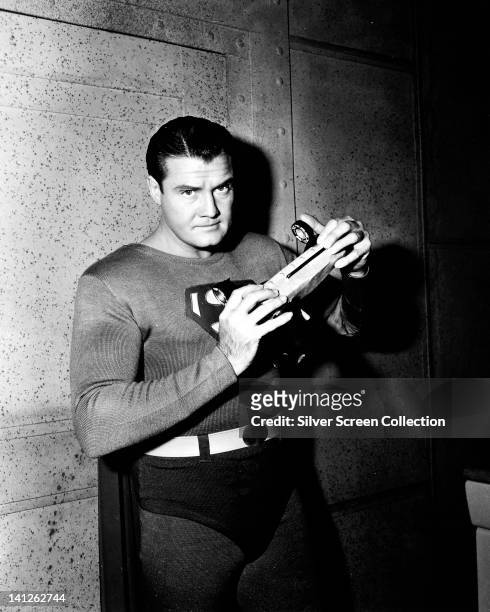 George Reeves , US actor, in costume in a publicity portrait issued for the US television series, 'Adventures of Superman', USA, circa 1955. The...