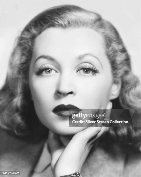 Headshot of Lilli Palmer , German actress, with her chin resting on her right hand, in a studio portrait, circa 1945.