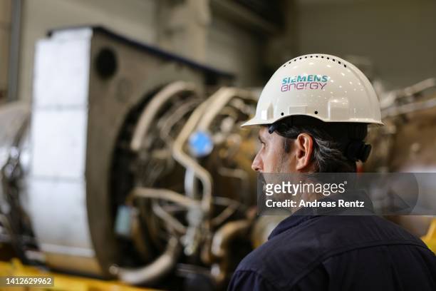 Siemens Energy technician looks at the Siemens gas turbine intended for the Nord Stream 1 gas pipeline in Russia at a Siemens Energy facility on...