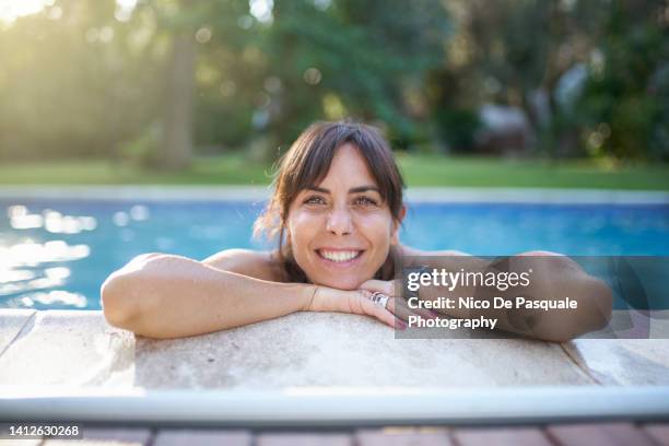 portrait of woman standing in a pool - bath relaxation stock pictures, royalty-free photos & images