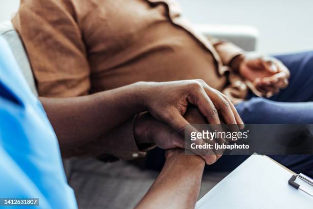 home caregiver and senior man holding hands. - demência imagens e fotografias de stock