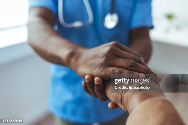 companionship and elder care go hand in hand - black doctor stock pictures, royalty-free photos & images