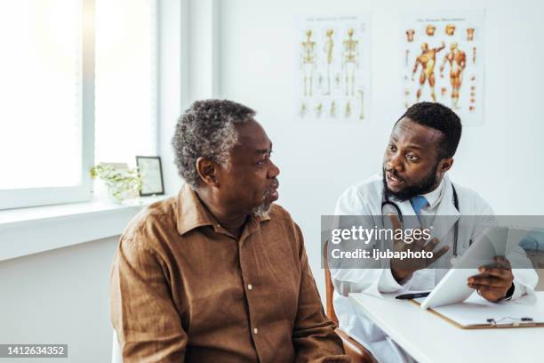 doctor listens seriously to patient concerns about drug side effects - medicaid stockfoto's en -beelden