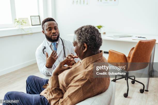 senior man looks at doctor in disbelief - medical shock stock pictures, royalty-free photos & images