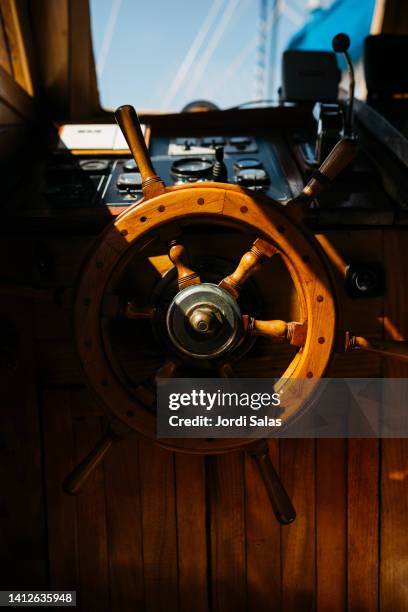 view of a wooden rudder of a nautical vessel - boat steering wheel stock pictures, royalty-free photos & images