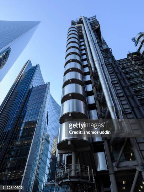 looking up at futuristic office towers in london financial district - lloyds of london stock-fotos und bilder