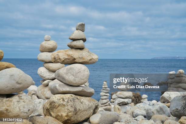 rock stacking photos and premium high res pictures -... A Piles Of Rocks Stacked On The Beach High-Res Stock Photo - Getty Images