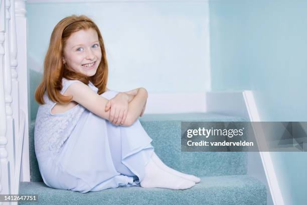 cute, auburn-haired girl sitting on the stairs - 9 steps stock pictures, royalty-free photos & images