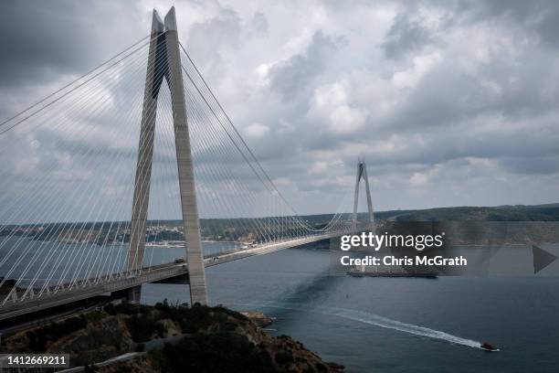 The Sierra Leone-flagged cargo ship Razoni transits the Bosphorus passing under the Yavuz Sultan Selim Bridge after being inspected by...