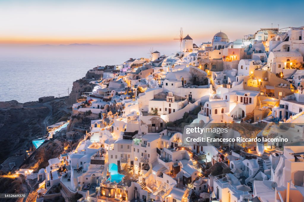 Oia, Santorini Island, Cyclades, Greece. cityscape, Houses and churches with bell, sea on background