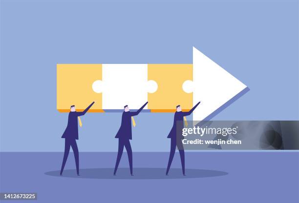 the white-collar workers marched forward holding the puzzle arrows. - man holding controller stock illustrations