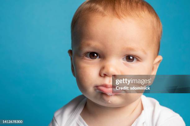 sad eleven month old baby boy - saliva substância orgânica imagens e fotografias de stock