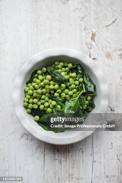 peas with spinach - side dish stock pictures, royalty-free photos & images