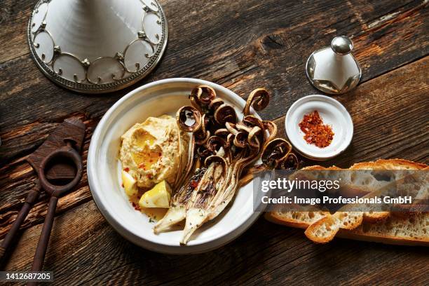 fried radicchio with hummus - radicchio stock pictures, royalty-free photos & images