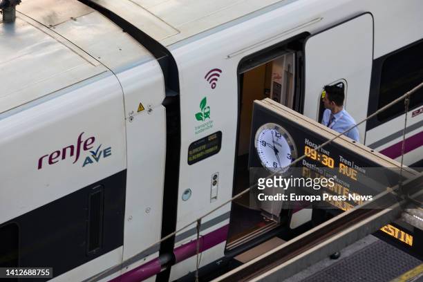 Renfe worker at the gates of an AVE train at Puerta de Atocha station on August 3 in Madrid, Spain. The Government has extended rail travel bonuses...