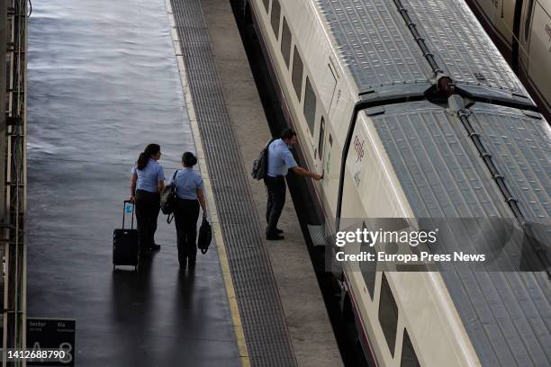 Renfe workers enter an AVE train at Puerta de Atocha station on August 3 in Madrid, Spain. The government has extended rail travel bonuses with a 50%...