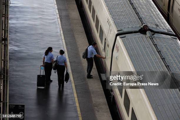 Renfe workers enter an AVE train at Puerta de Atocha station on August 3 in Madrid, Spain. The government has extended rail travel bonuses with a 50%...