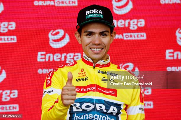 Sergio Andres Higuita Garcia of Colombia and Team Bora - Hansgrohe celebrates winning the Yellow Leader Jersey on the podium ceremony after the 79th...