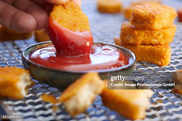 chicken nuggets with ketchup; one halved - chicken nuggets ストックフォト��と画像