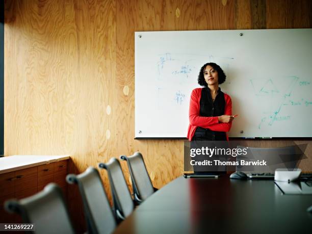 business woman standing in office conference room - estilo regency fotografías e imágenes de stock