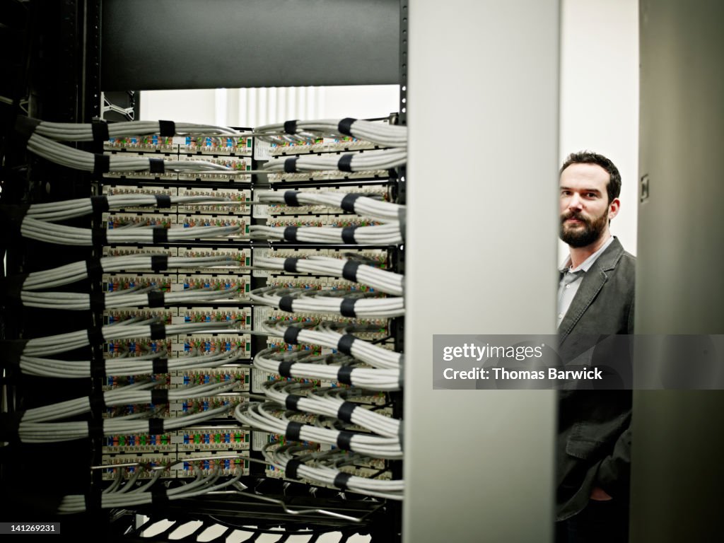 Businessman standing in server room