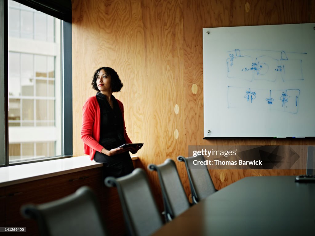 Businesswoman sitting near windows in office