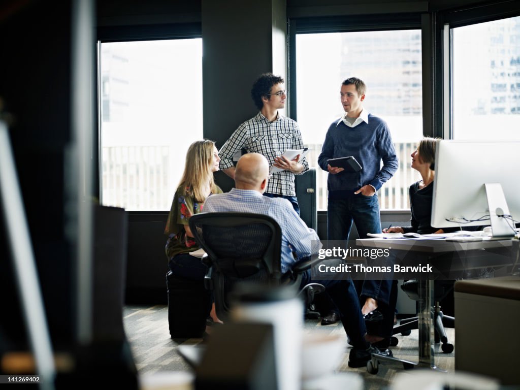 Businessman leading discussion in office